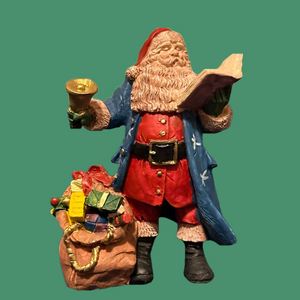 Gorgeous blue robed Santa rings a bell and reads to the crowds!